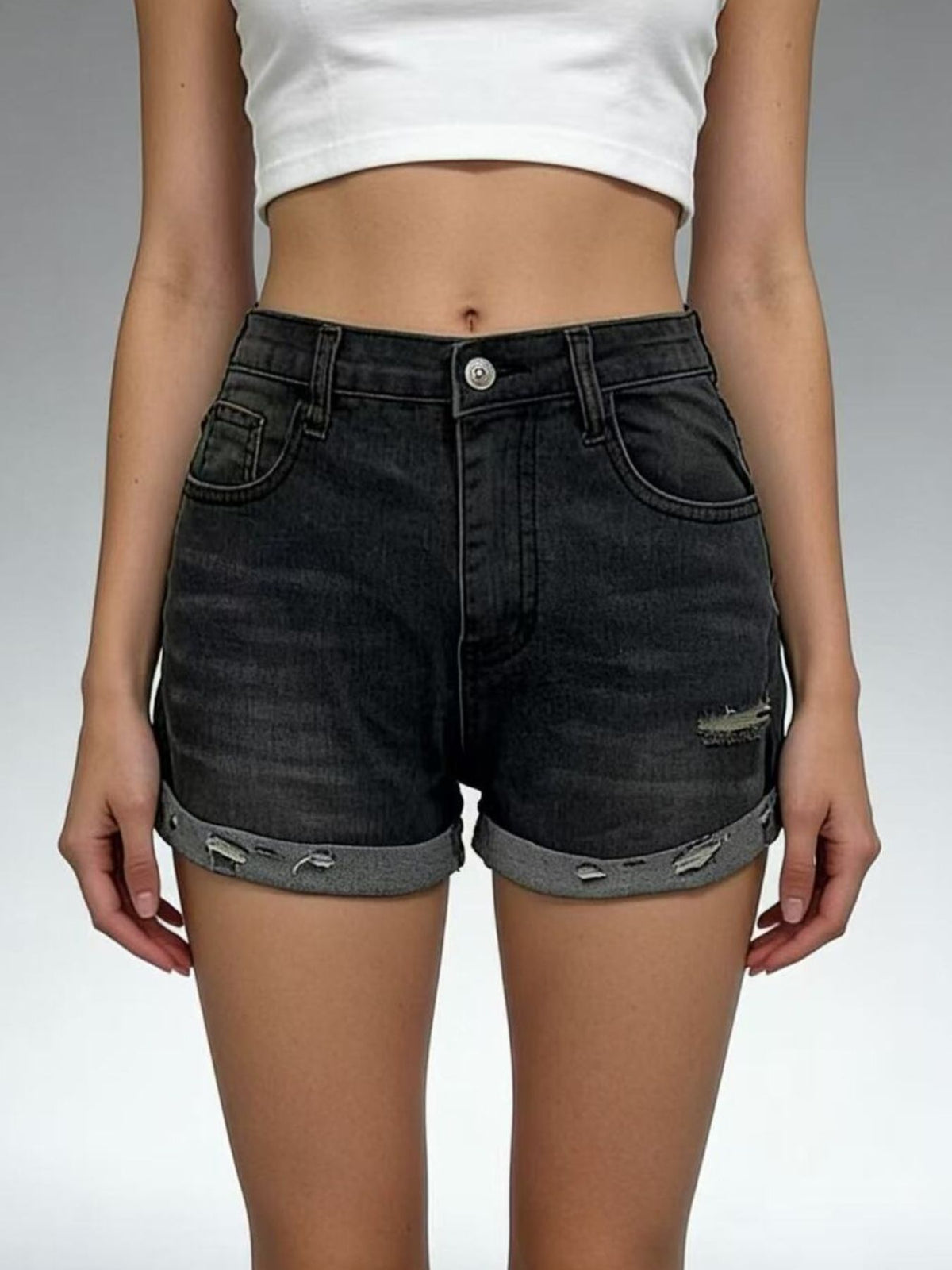 Black distressed denim shorts with rolled cuffs and button fly