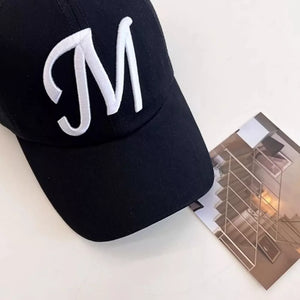 Black baseball cap with embroidered white M detail