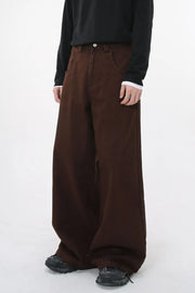 Wide-leg brown denim jeans with sculpted volume and a relaxed fit.
