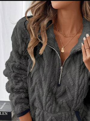 Dark gray sherpa half zip sweatshirt with chevron texture and silver zipper.
