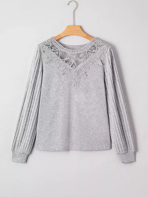 Gray ribbed knit long-sleeve top with intricate lace yoke detail