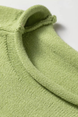 Light green knit sweater with a rolled collar and textured stitch detail.