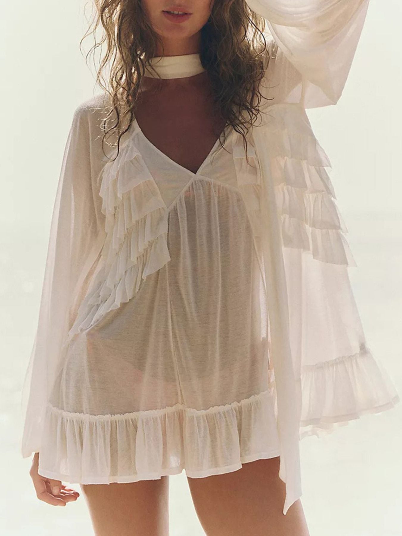 Sheer white ruffle trim beach cover-up with V-neck and long sleeves.