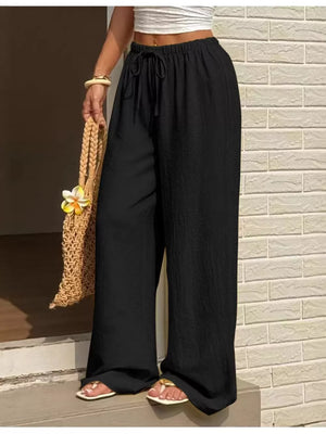 Black wide-leg linen pants with drawstring waist and textured fabric