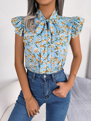 Light blue floral blouse with neck-tie and ruffle sleeves