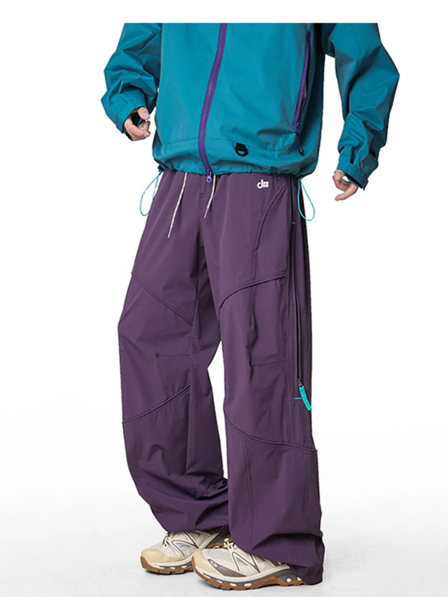 Relaxed fit cargo pants in Meadow Purple with drawstring and zippered pockets.