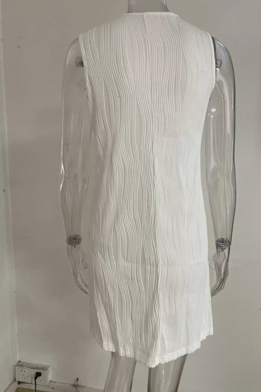 White textured mini dress with V-neck and ring straps, cotton blend fabric.