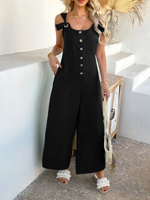 Black linen button-down wide-leg jumpsuit with tie straps and scoop neck.
