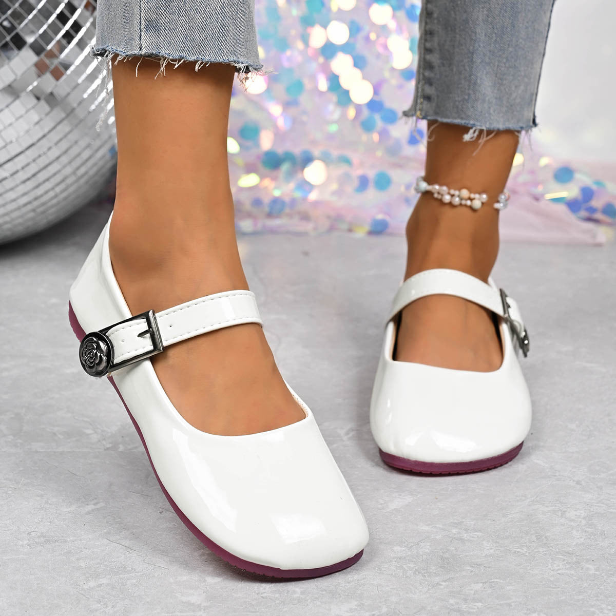 White buckle strap Mary Jane loafers with a rose detail on the buckle.