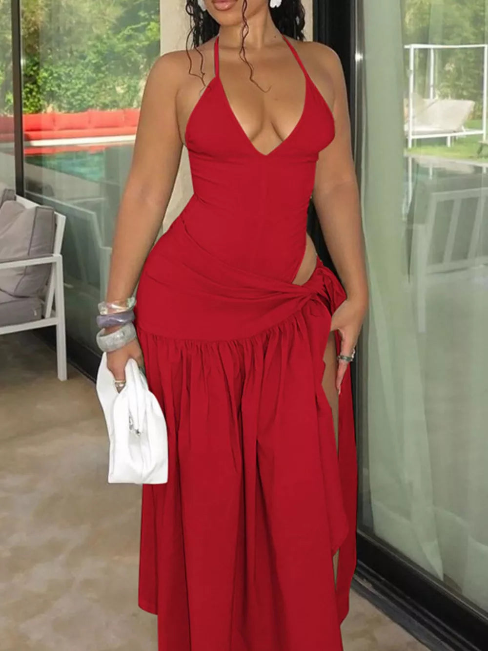 Red halter neck ruched maxi dress with deep v-neck and thigh-high slit.