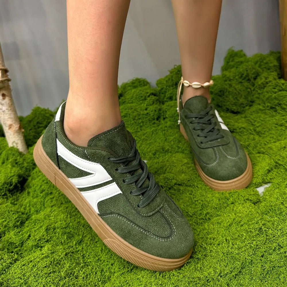 Green suede panel sneakers with white stripe detail and gum sole.