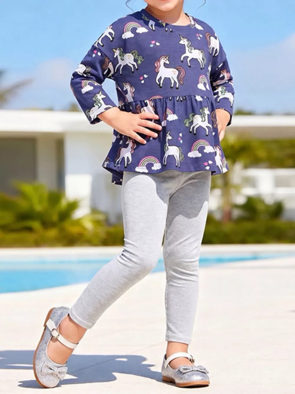 navy blue peplum top with unicorn print and round neck