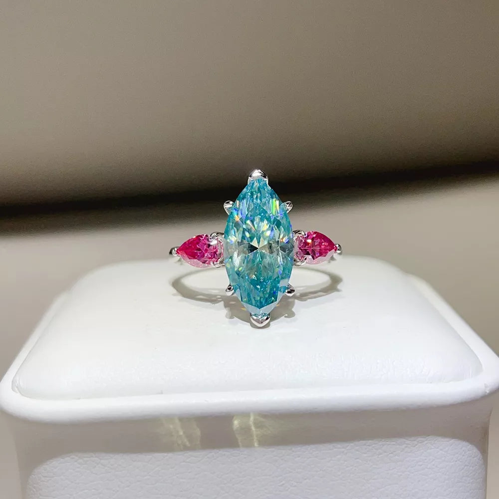ring in aqua featuring moissanite stones and elongated fit