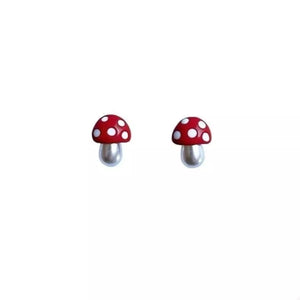 Red mushroom stud earrings with white polka dots and pearl stems.