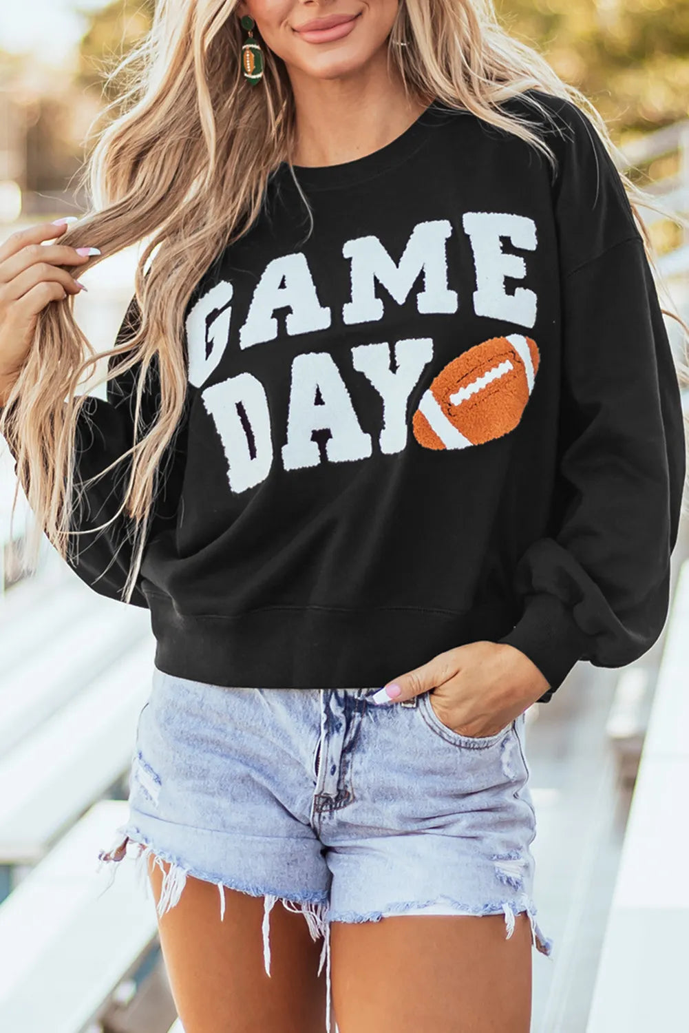 Black graphic sweatshirt with white "GAME DAY" text and football graphic