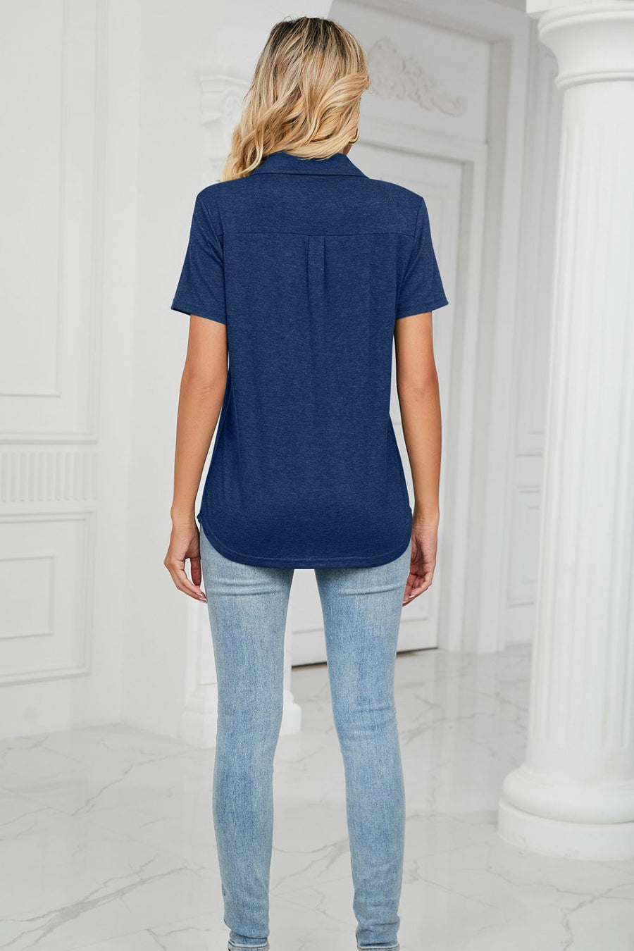 Navy V-neck polo shirt with short sleeves and a pocket detail.