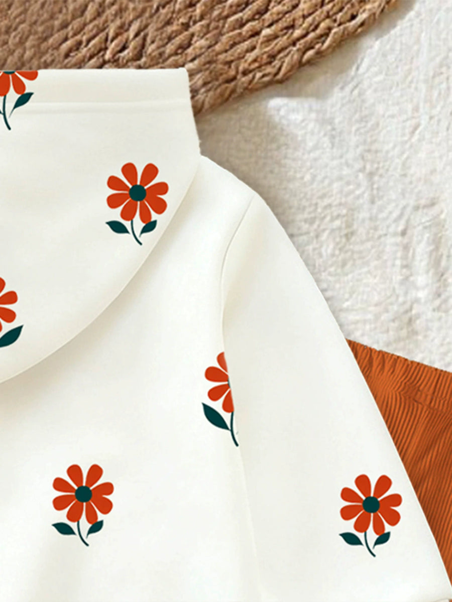 Baby white hoodie with allover red floral print and orange pants.