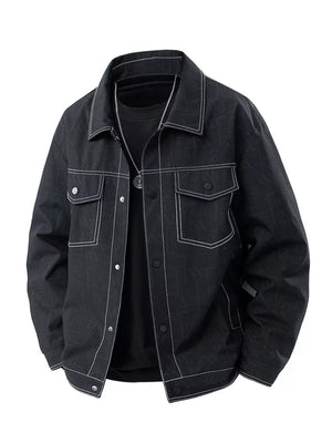 Oversized black denim trucker jacket with white contrast stitching and snap front.