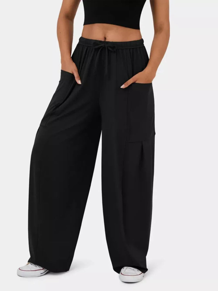 Black maternity wide-leg pants with drawstring waist and cargo pockets.