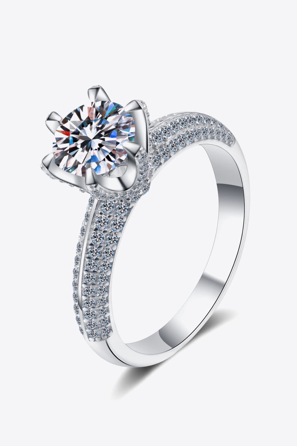 Silver pavé halo moissanite solitaire ring with a round cut center stone.