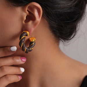 Braided leather and gold hoop earrings in coffee brown.