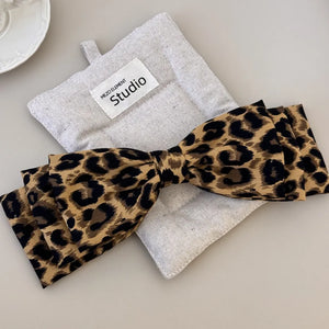 Leopard print oversized hair bow with fabric bow detail.