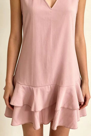 Dusty pink polyester mini dress with V-neck and tiered ruffle hem.