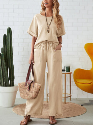 Relaxed linen co-ord set in tan, featuring a wide-leg pant with pockets and a short-sleeve top.