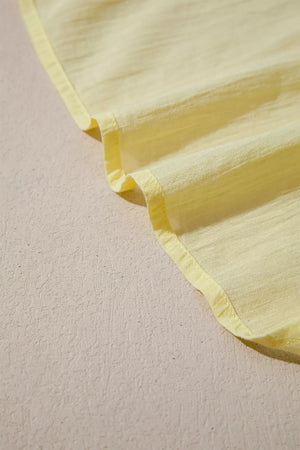 Yellow cotton blend shirt with ruffled hem detail