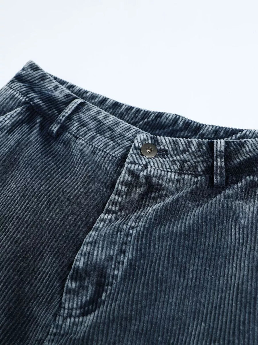 Blue corduroy cargo pants with textured fabric and button closure.