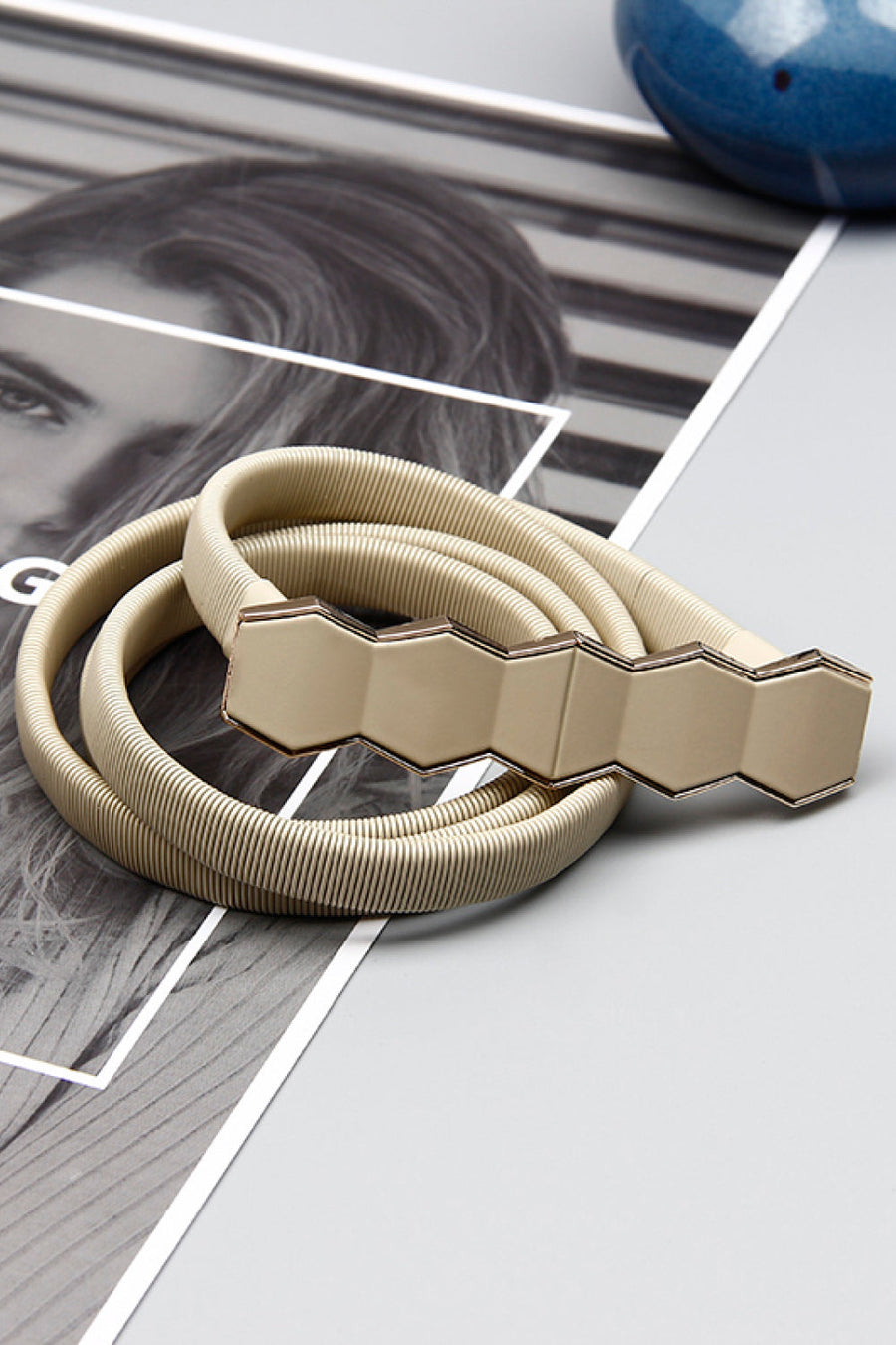 Cream elastic belt with geometric buckle detail