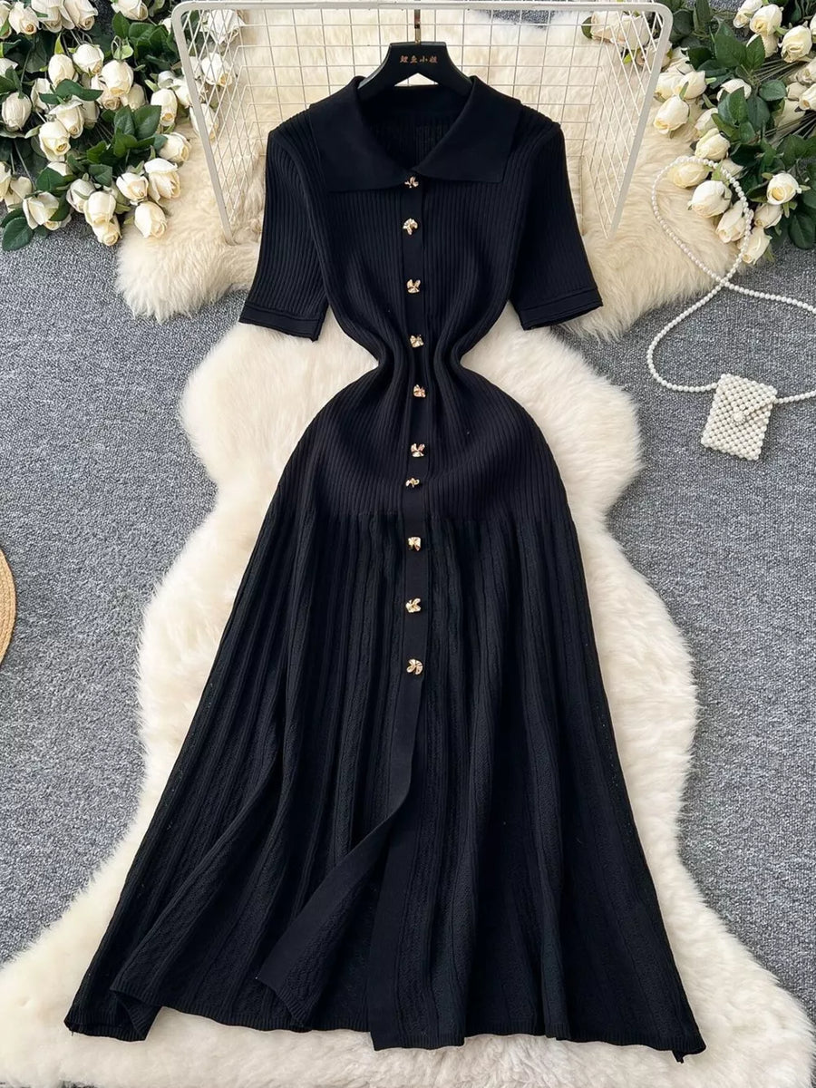 Black knit Peter Pan collar dress with gold buttons and short sleeves.