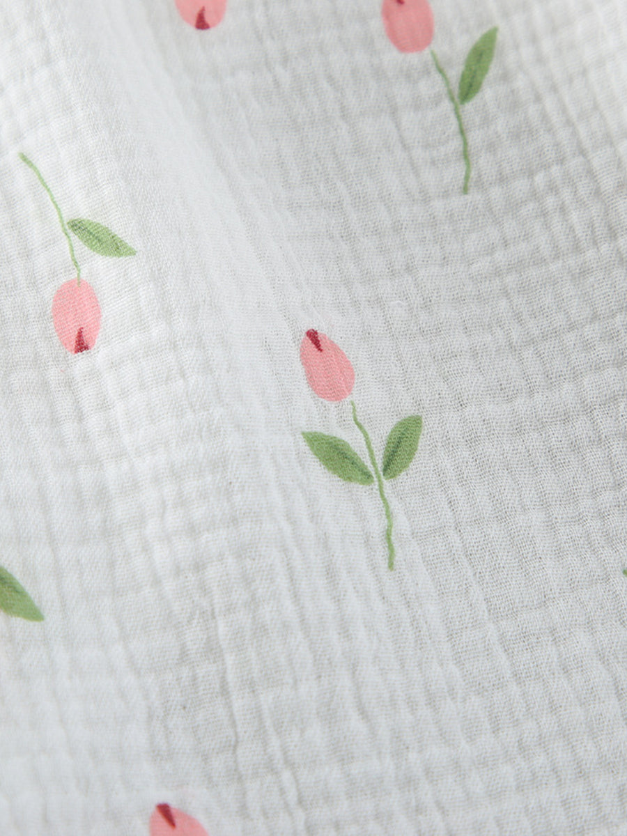 Floral print cotton robe with pink blooms and green leaves on white gauze fabric.