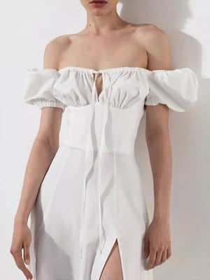 White puff sleeve tie front midi dress with off-the-shoulder neckline and thigh slit.