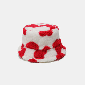 Fuzzy sherpa bucket hat in deep red polka dot pattern.