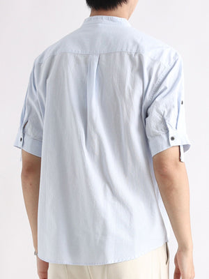 Light blue band collar button-down shirt with rolled sleeves and back pleats.
