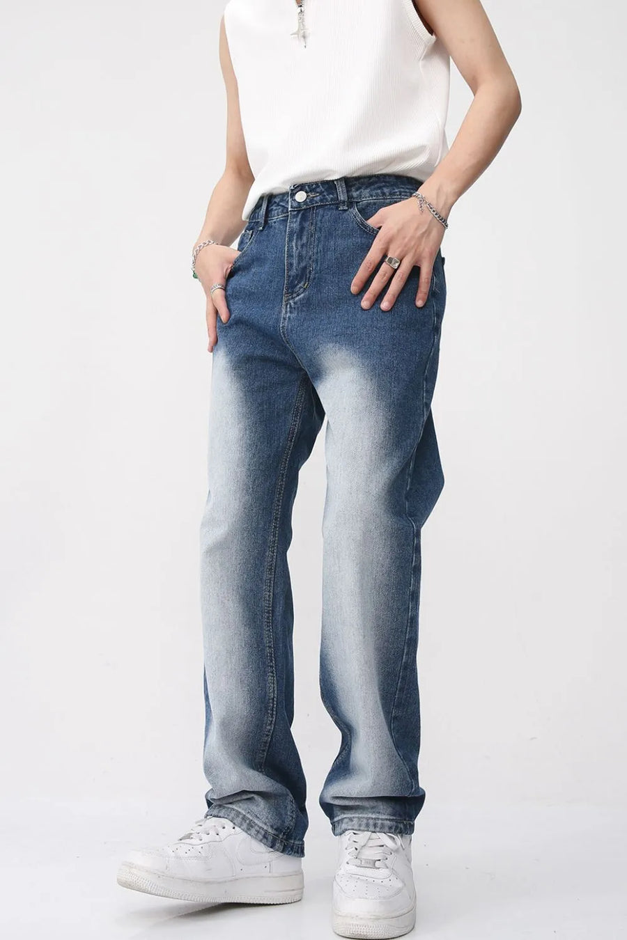 Faded wash baggy jeans in medium blue denim with a relaxed fit and gradient effect.