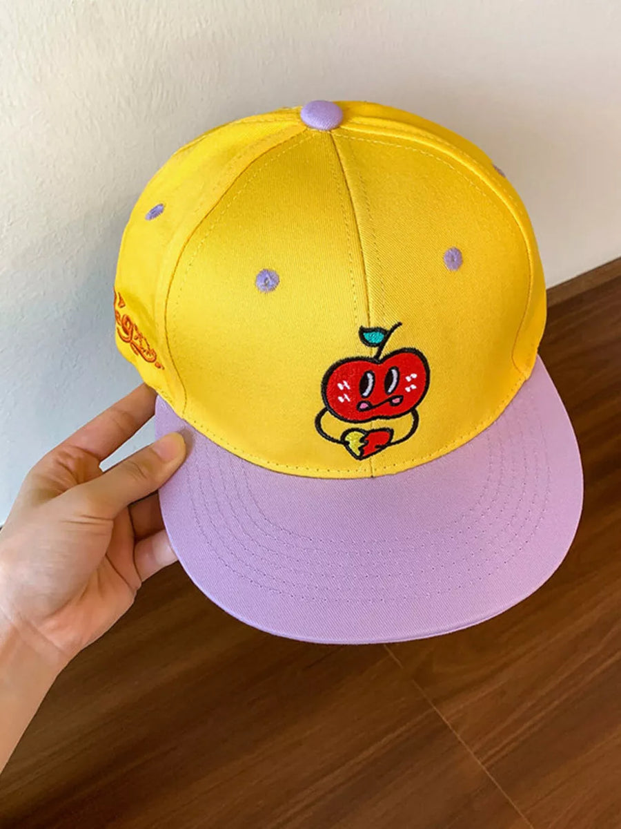 Yellow baseball cap with purple brim and embroidered apple graphic.