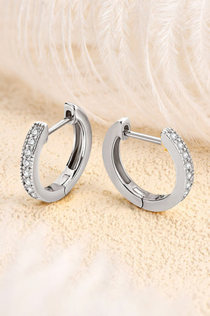 Silver pave-set huggie hoop earrings with sparkling stones.