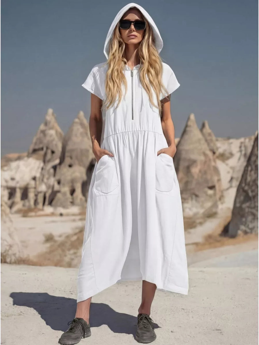 White hooded midi dress with short sleeves, zip neck, elastic waist, and large patch pockets.