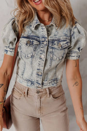 Cropped denim bolero jacket with puff sleeves and distressed details in medium wash.