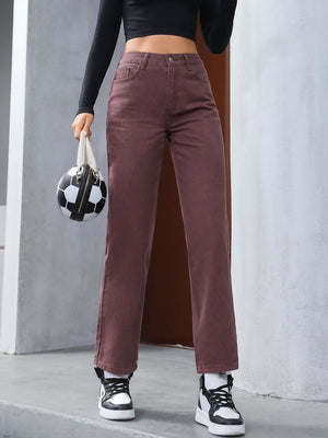 Relaxed straight leg jeans in dark brown with buttoned fly, styled with sneakers and a soccer ball bag.