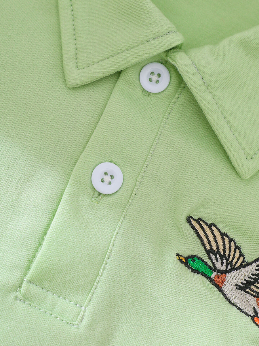 Light green cotton polo shirt with embroidered duck detail and white buttons