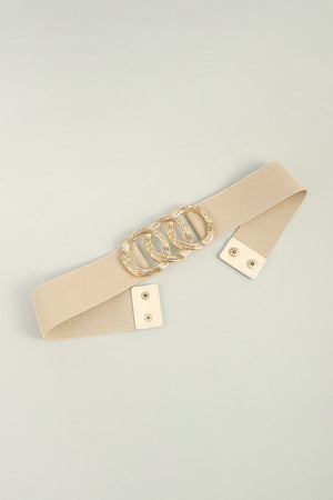 Tan elastic belt with triple gold ring buckle detail and faux leather snap closure.