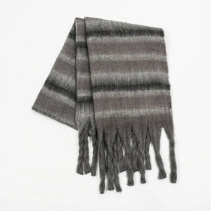 Textured stripe fringe scarf in dark gray with soft fuzzy material and braided fringe details.