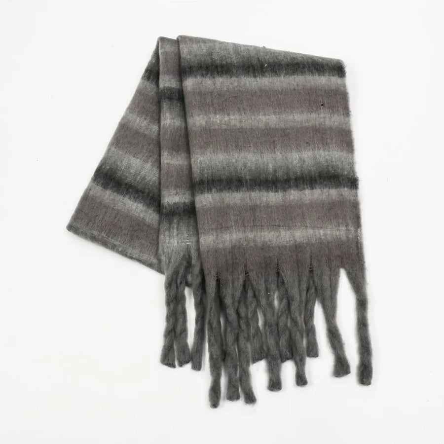 Textured stripe fringe scarf in dark gray with soft fuzzy material and braided fringe details.