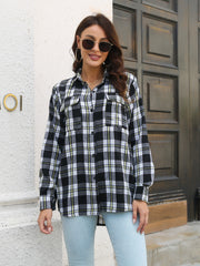 Black plaid overshirt with buttoned flap pockets and collared neckline.