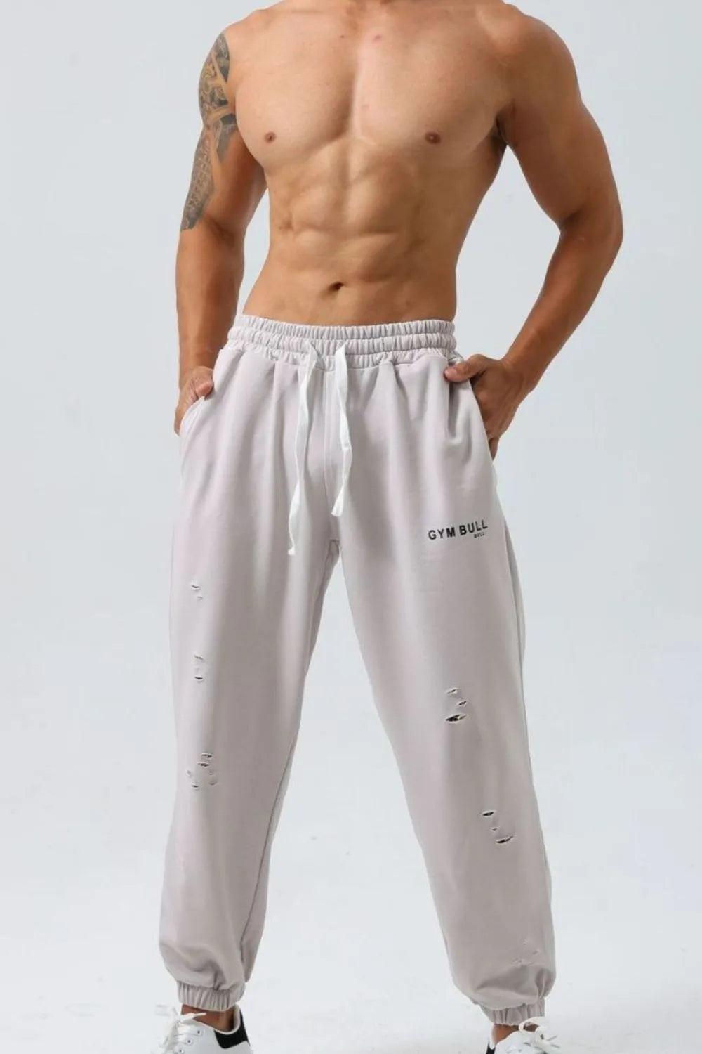 Gray distressed jogger trousers with drawstring and Gym Bull logo