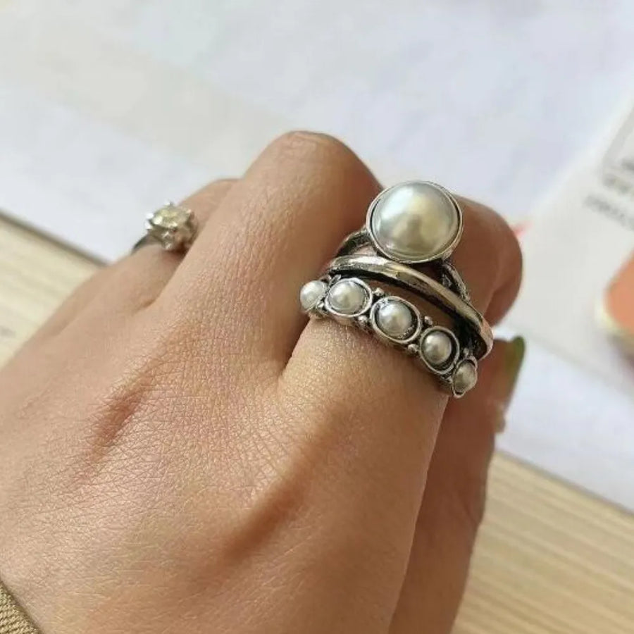 Silver trilogy ring with pearl cluster and smaller pearls.