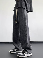 Oversized drawstring jeans in dark gray wash with a loose fit and casual styling.